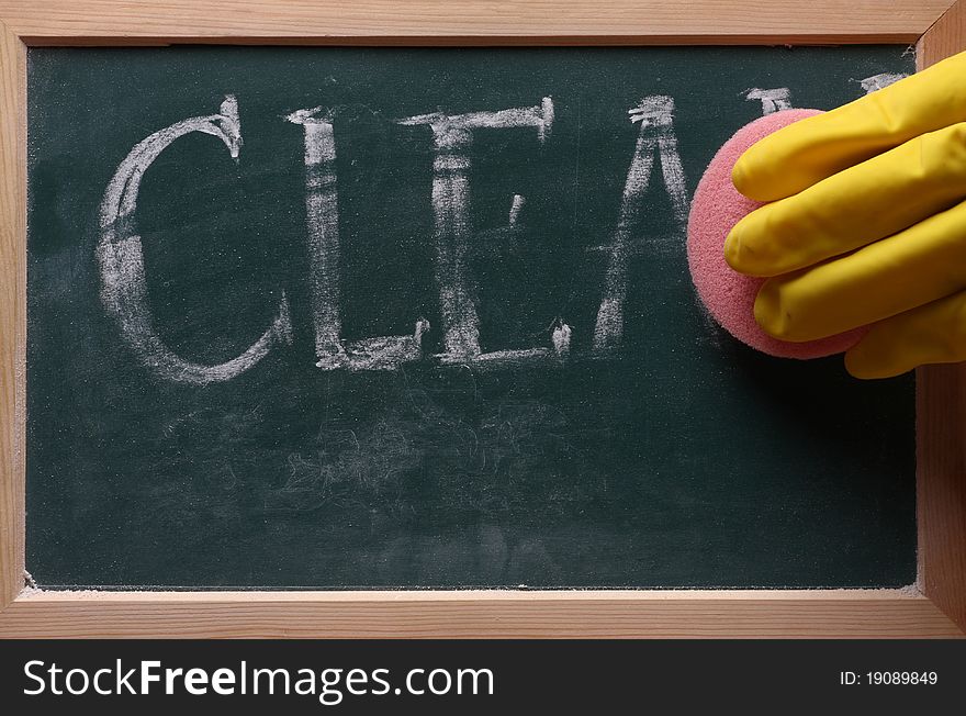 Hand with sponge clean blackboard. Hand with sponge clean blackboard