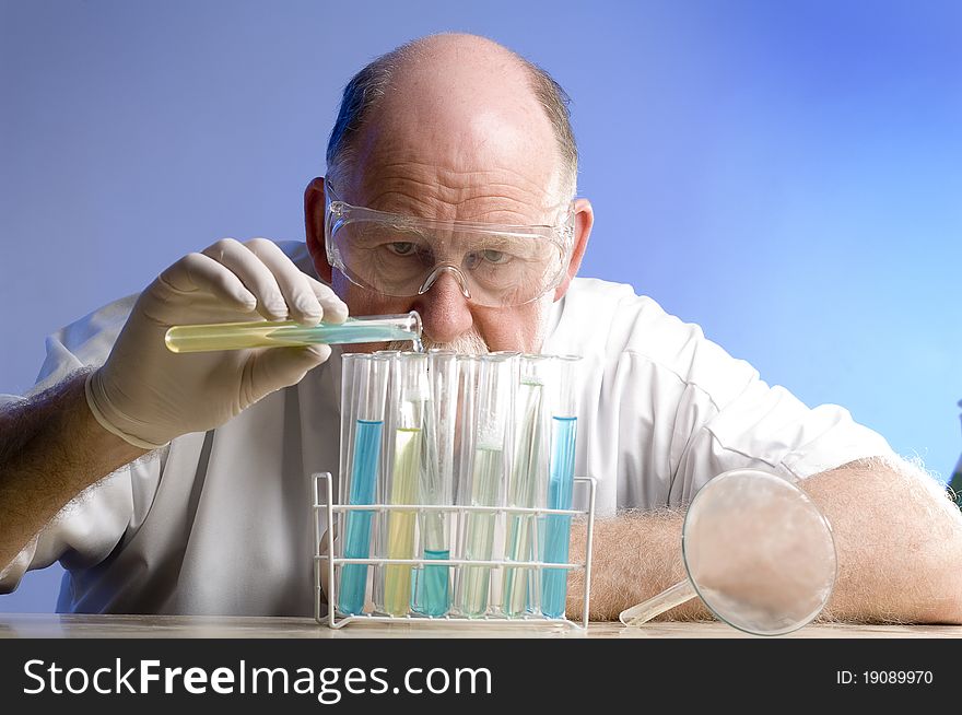 Scientist working with chemicals on blue background