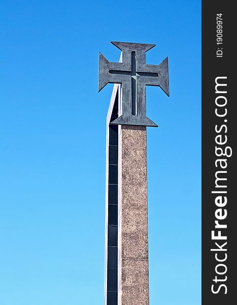 Christian portuguese cross with ancient origins and used in the discoveries, isolated, with the blue sky as background
