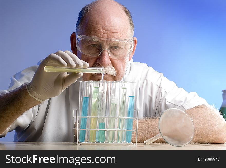 Scientist working with chemicals on blue background