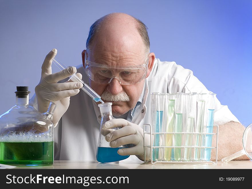 Scientist working with chemicals on blue background