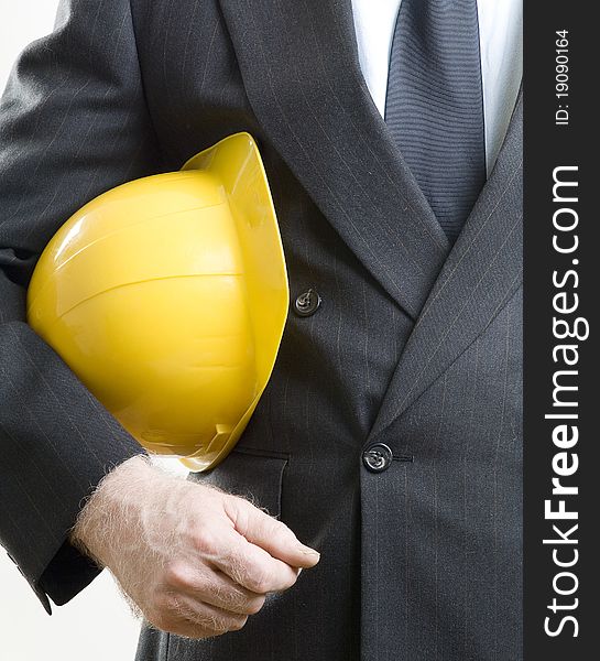 Yellow construction hat under arms