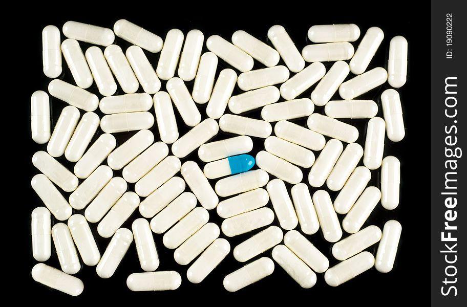 Pills (capsules) on black background