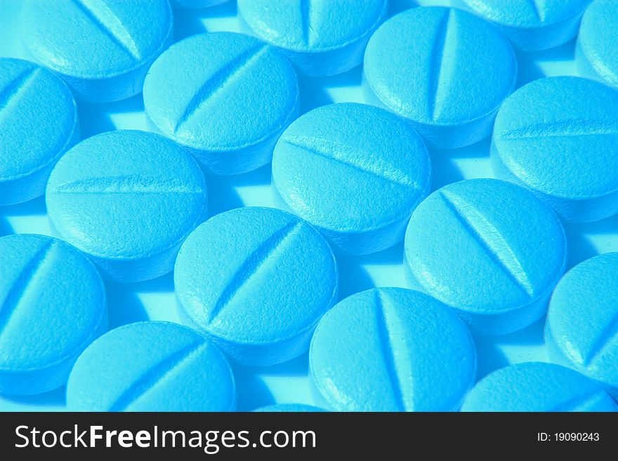 Pills background with blue lighting (close-up view)