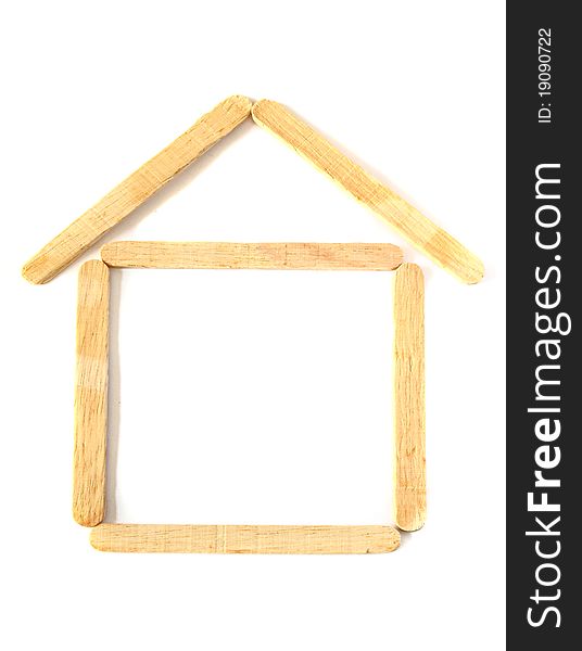 Wood ice-cream stick in shape as a house on white background