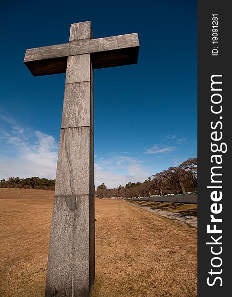 Christian cross on a field, with a nice blue sky