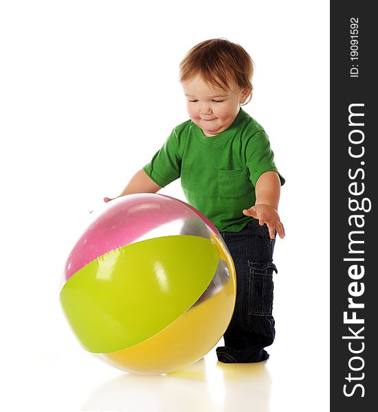An adorable toddler catching a colorful beachball. Isolated on white. An adorable toddler catching a colorful beachball. Isolated on white.