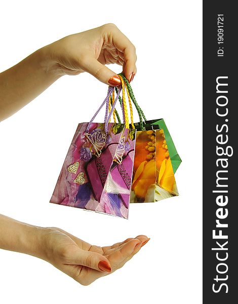 A girl holding shopping bags in hand, supports the second hand. A girl holding shopping bags in hand, supports the second hand