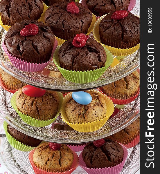 Chocolate and raspberry cupcakes on glass etagere