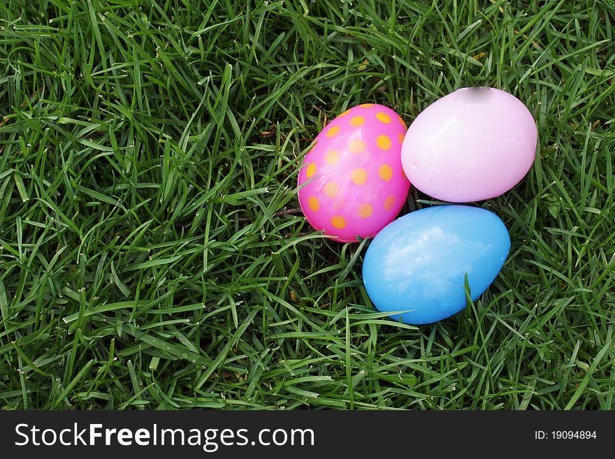 Easter eggs hidden in the grass for children to find on Easter. Easter eggs hidden in the grass for children to find on Easter.