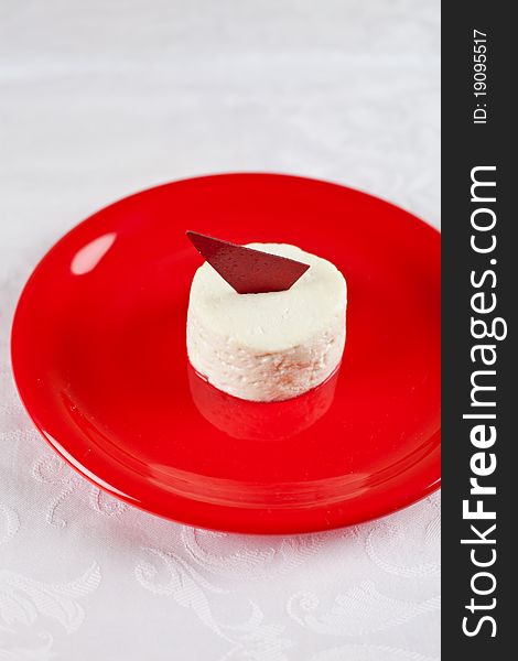 Ricotta cheese dessert over red plate