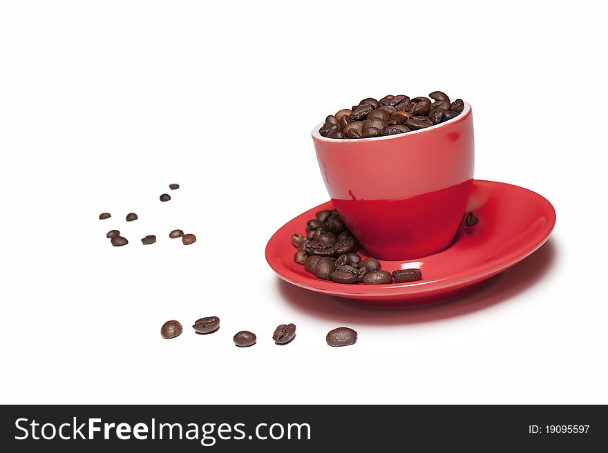 A cup full of coffee beans isolated on white