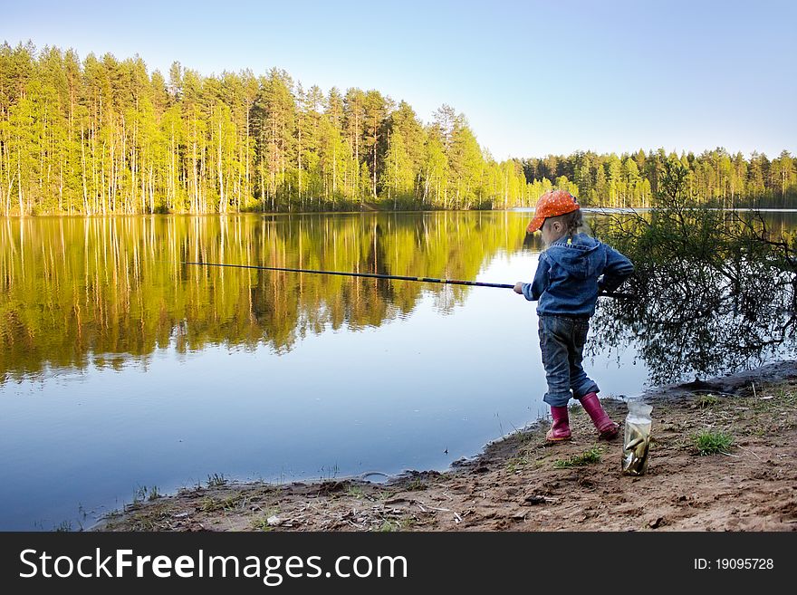 Girl on the lake fishing.