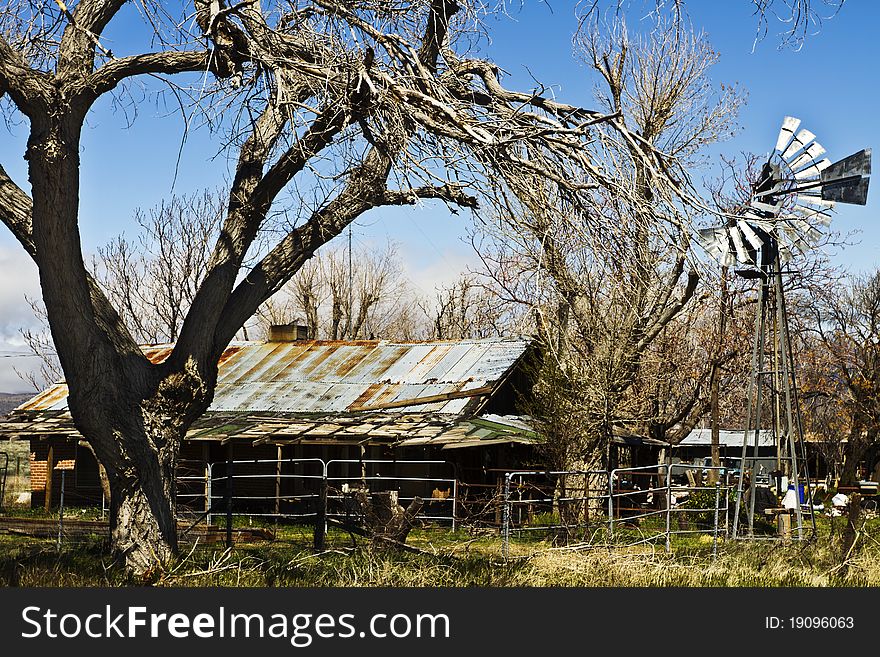 Dilapidated Desert Farm House With Windmill