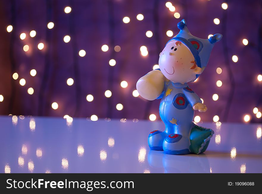Baby doll goes to sleep in christmas light environment. Baby doll goes to sleep in christmas light environment