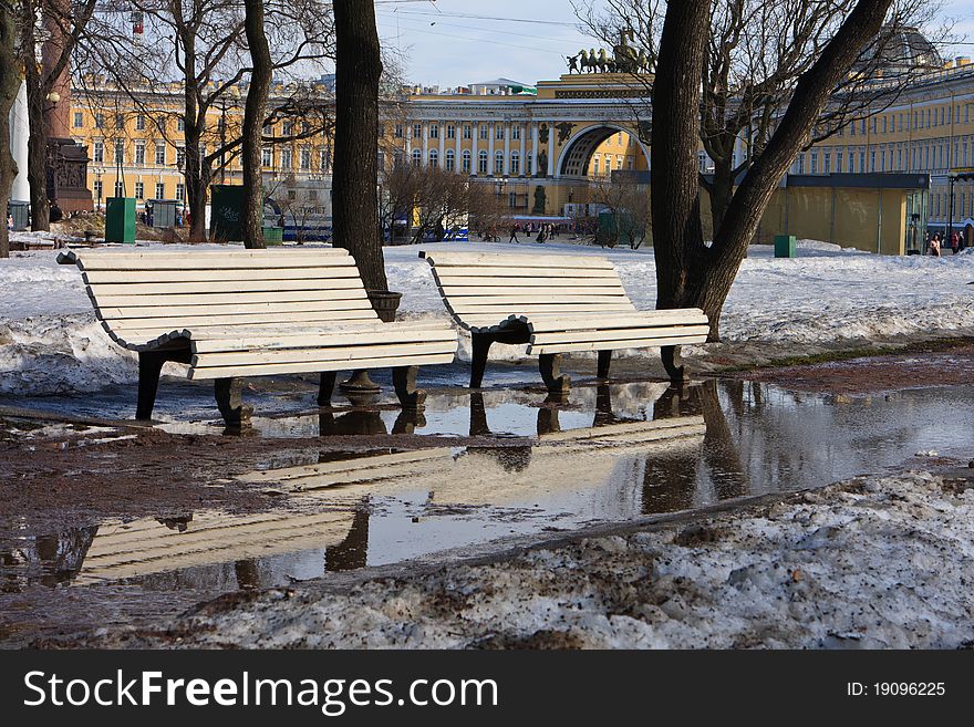 Spring in Saint-Petersburg. Two benches near the famous Palace Square.