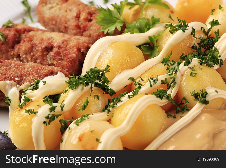 Cevapcici with potatoes, mayonnaise and mustard - detail. Cevapcici with potatoes, mayonnaise and mustard - detail