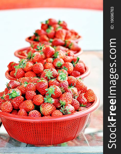 Strawberries with leaves in basketes