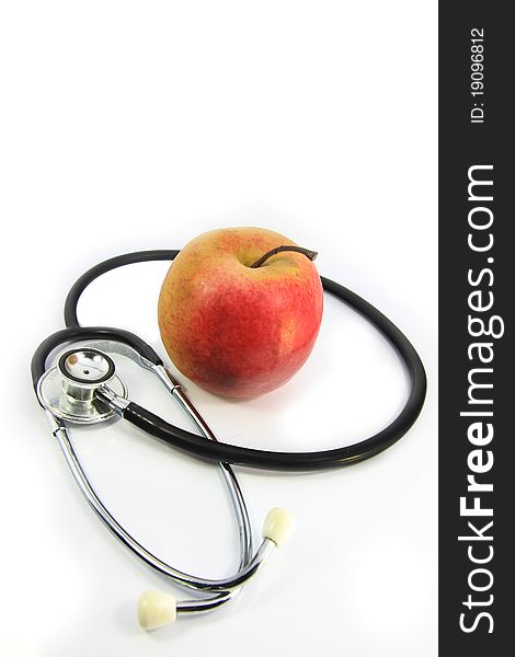Apple and stethoscope on white background. Apple and stethoscope on white background