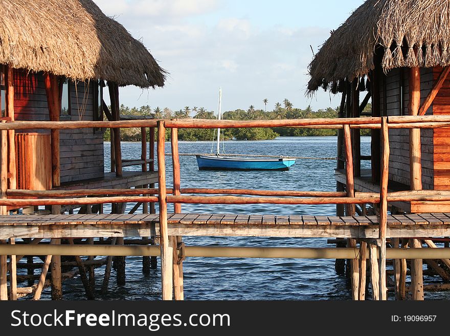 Beautiful hut in the water with a boat beside. Beautiful hut in the water with a boat beside