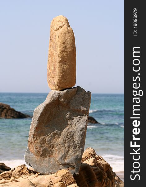 Beach with balanced rocks, by the sea