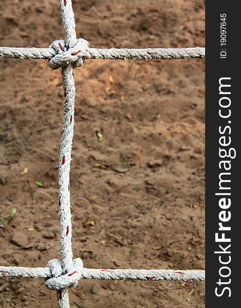 Rope with knots on the background of the sand