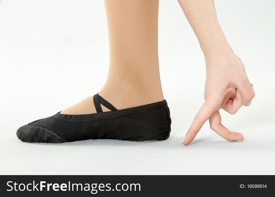Dancer feet and teacher hand close-up. Dancer feet and teacher hand close-up