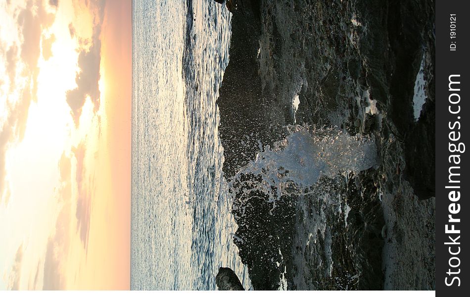 Water rushing out of a blow hole in the rocks at sunset in the caribbean. Water rushing out of a blow hole in the rocks at sunset in the caribbean