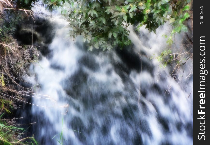 A river streaming toward the camera. very saturated stream blur. A river streaming toward the camera. very saturated stream blur.