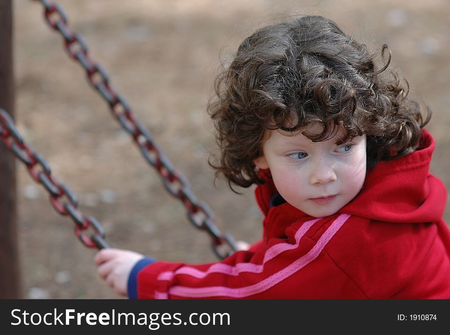 Girl on a swing, outdoors on a sunny day