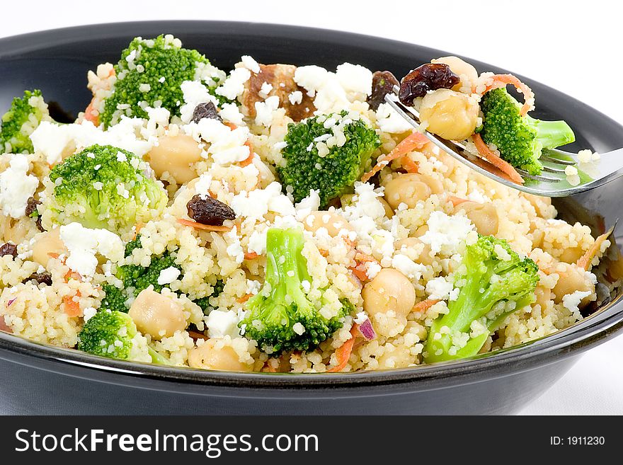 Combine couscous, broccoli, shredded carrots, raisins, nuts, garbanzo beans, and seasonings top with feta cheese and serve hot or cold. Combine couscous, broccoli, shredded carrots, raisins, nuts, garbanzo beans, and seasonings top with feta cheese and serve hot or cold.