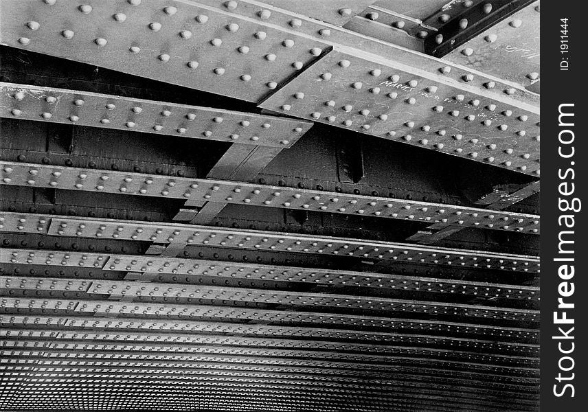 Iron and rivet construction of underside of bridge in camden