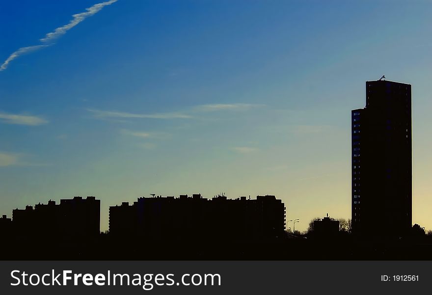 Skyline silhouette against blue sky with some clouds