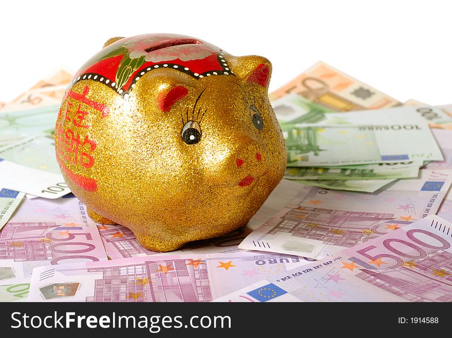 Piggy bank over bills and white background. Piggy bank over bills and white background