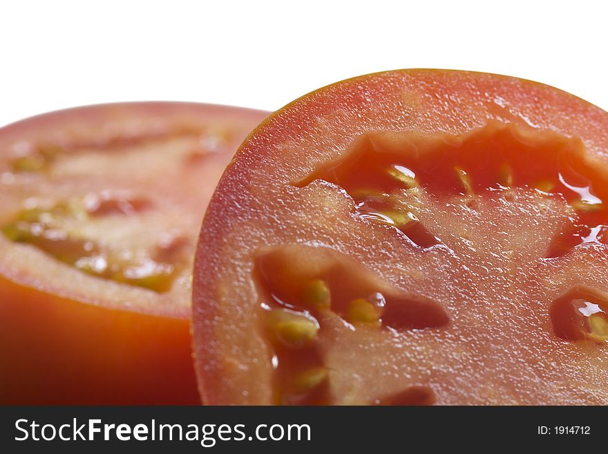 The cut tomato. Isolated. Close-up.