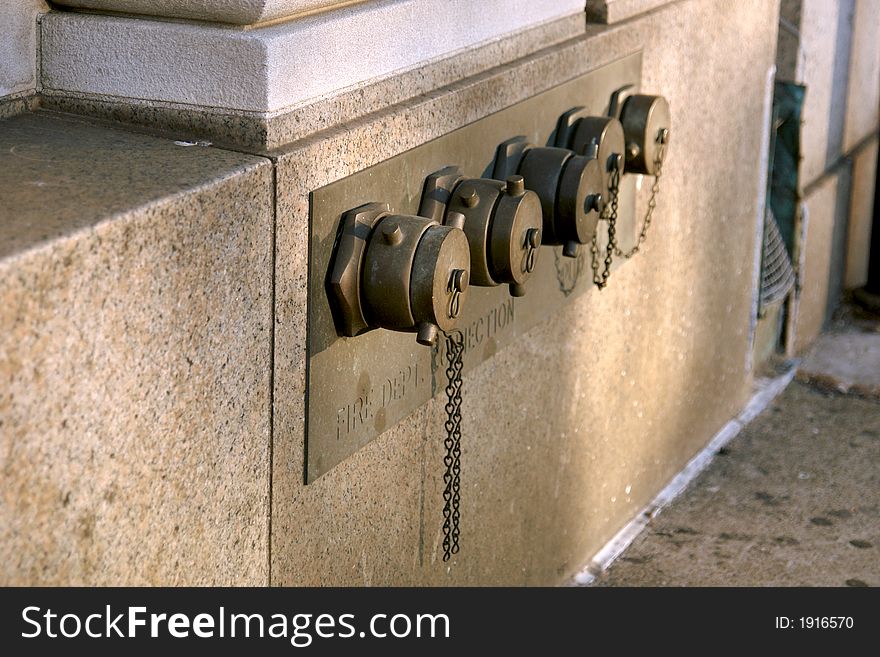 Aged brass covers for the fire department water connection and pump. Aged brass covers for the fire department water connection and pump