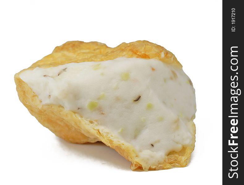 A piece of fried tofu isolated over white background