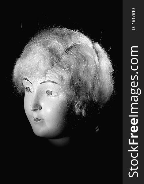 Picture of a old porcelain doll head.
Lighted with a spot light on black and white. Picture of a old porcelain doll head.
Lighted with a spot light on black and white