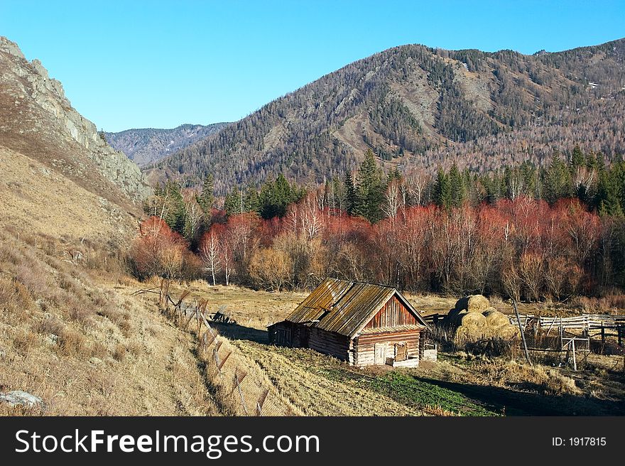 Old house, blue sky and mountains.