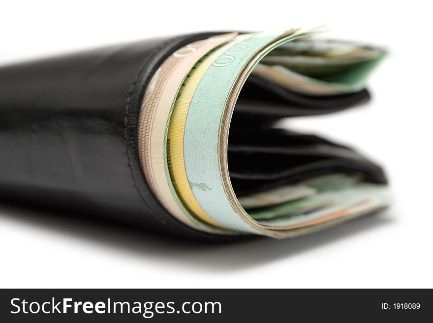 Close view on a black leather wallet full of banknotes. White background. Close view on a black leather wallet full of banknotes. White background.