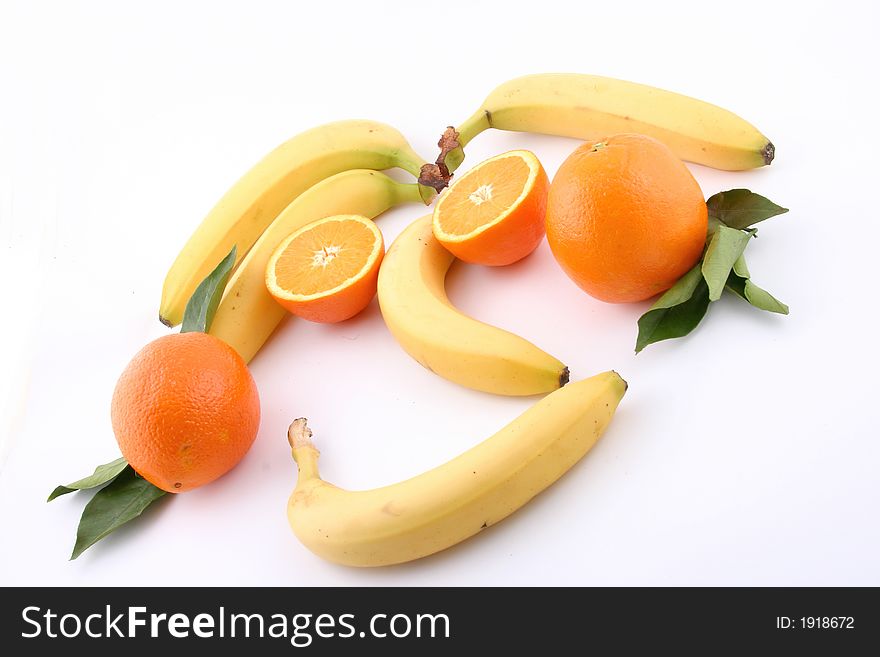 Fresh bananas and orange on white background (fruits, food, vitamin)