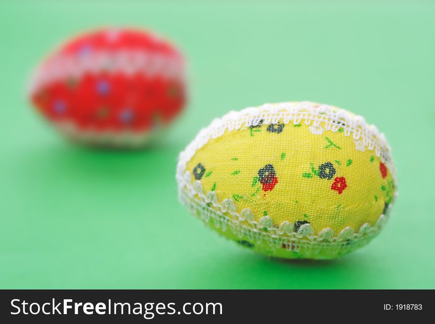 Two easter eggs on the green background - the symbol of spring