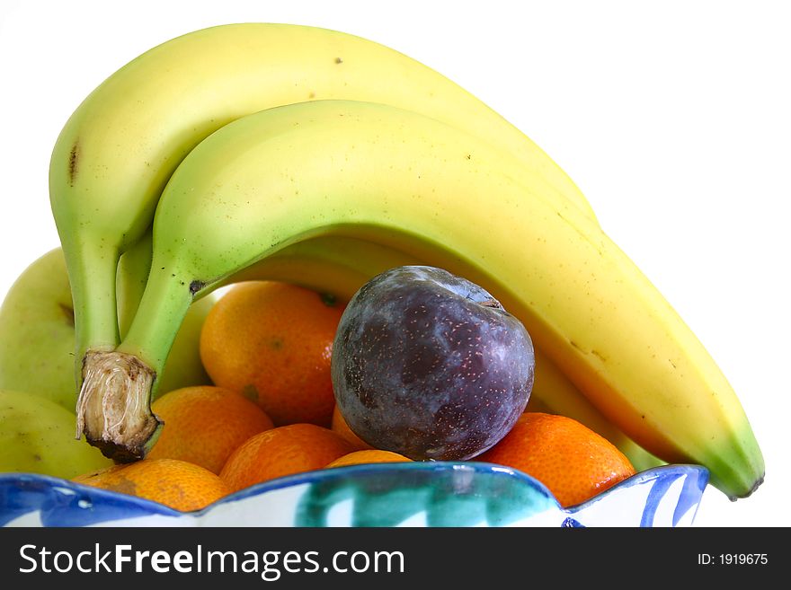 Bowl of fresh fruit isolated over a white background. Bowl of fresh fruit isolated over a white background