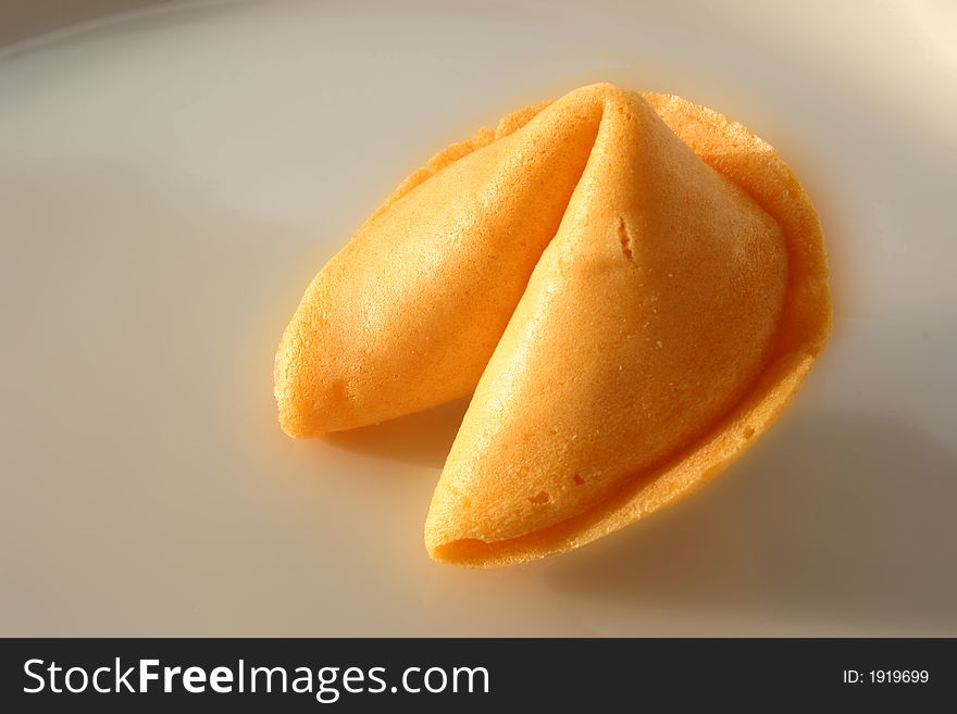 Open fortune cookie with the slip of paper sticking out