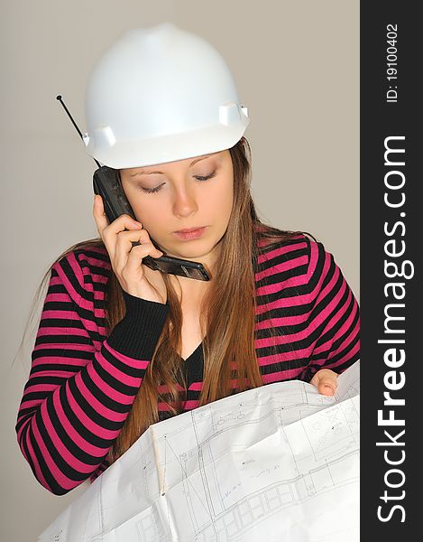 Girl, construction engineer talk back in the hands of construction drawings to explain something to the customer. Girl, construction engineer talk back in the hands of construction drawings to explain something to the customer