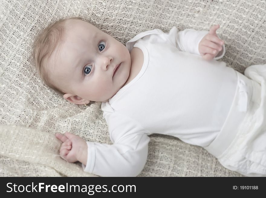 Little baby with blue eyes in white. Little baby with blue eyes in white