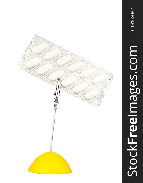 Yellow memo holder with pills in blister. Yellow memo holder with pills in blister