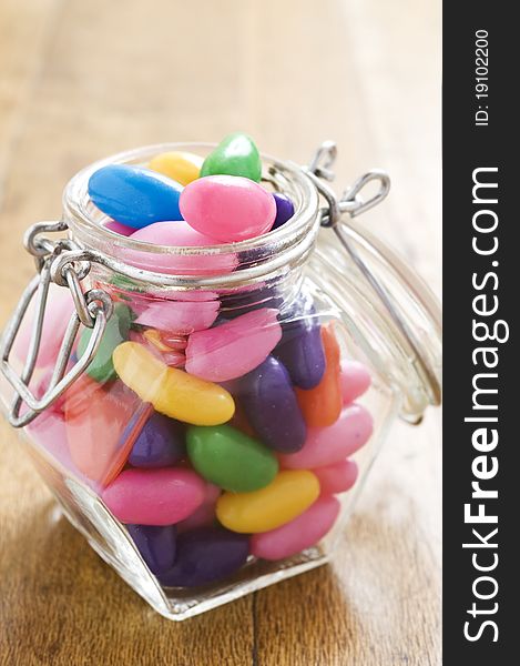 Colorful jelly beans in a bottle - very shallow depth of field