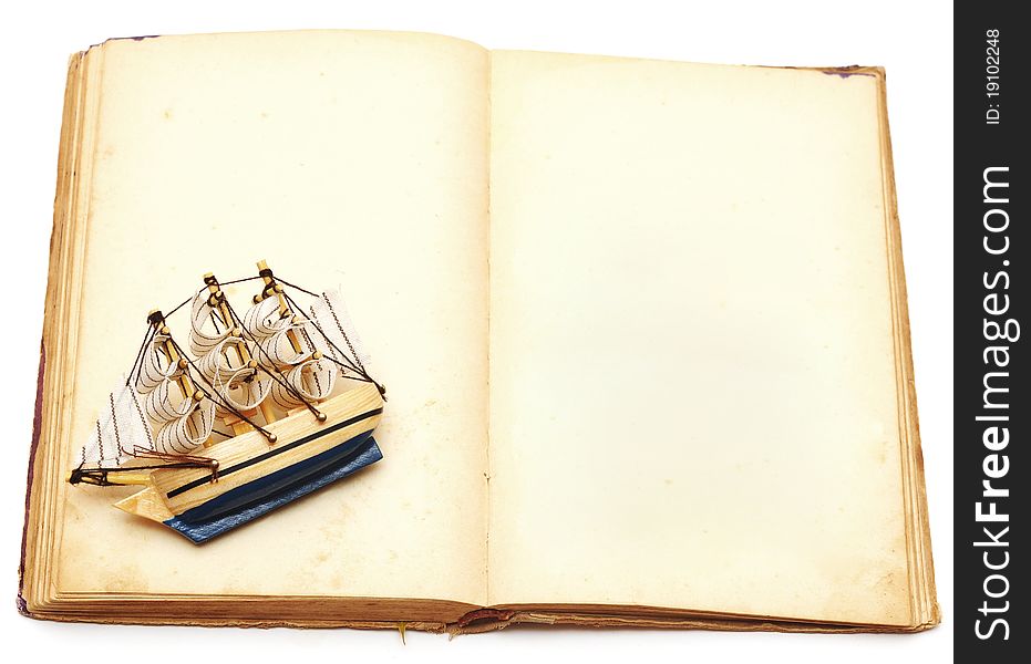 Old book and ship on white background