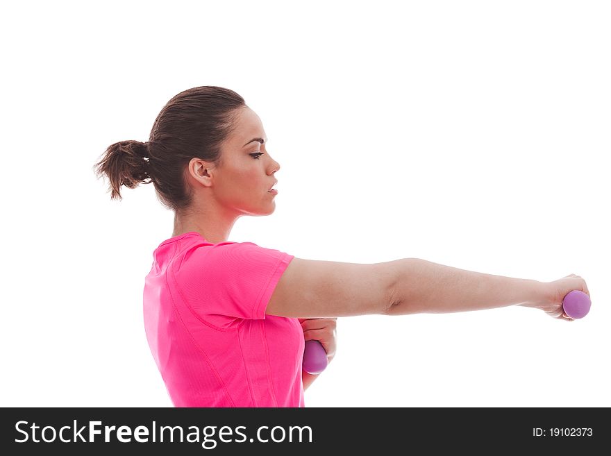 A young female in a pink top performing an exercise with weights. A young female in a pink top performing an exercise with weights